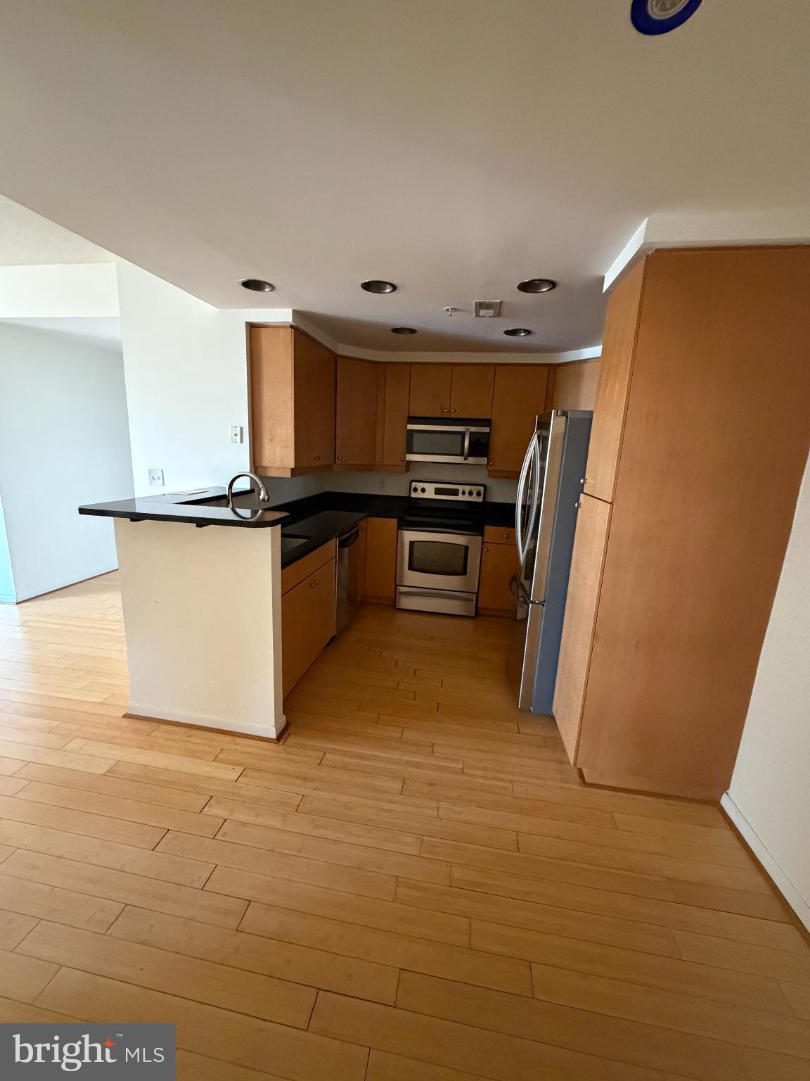 1111 11th Street Northwest, Unit 608 Washington, DC 20001 - Photo 20 of 29 a kitchen with stainless steel appliances a refrigerator and a stove