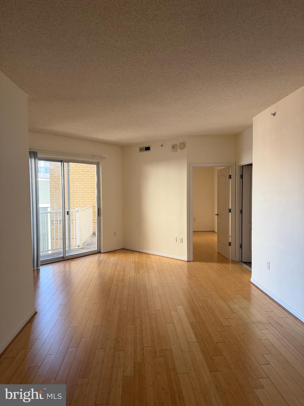 1111 11th Street Northwest, Unit 608 Washington, DC 20001 - Photo 22 of 29 a view of an empty room with wooden floor and a window