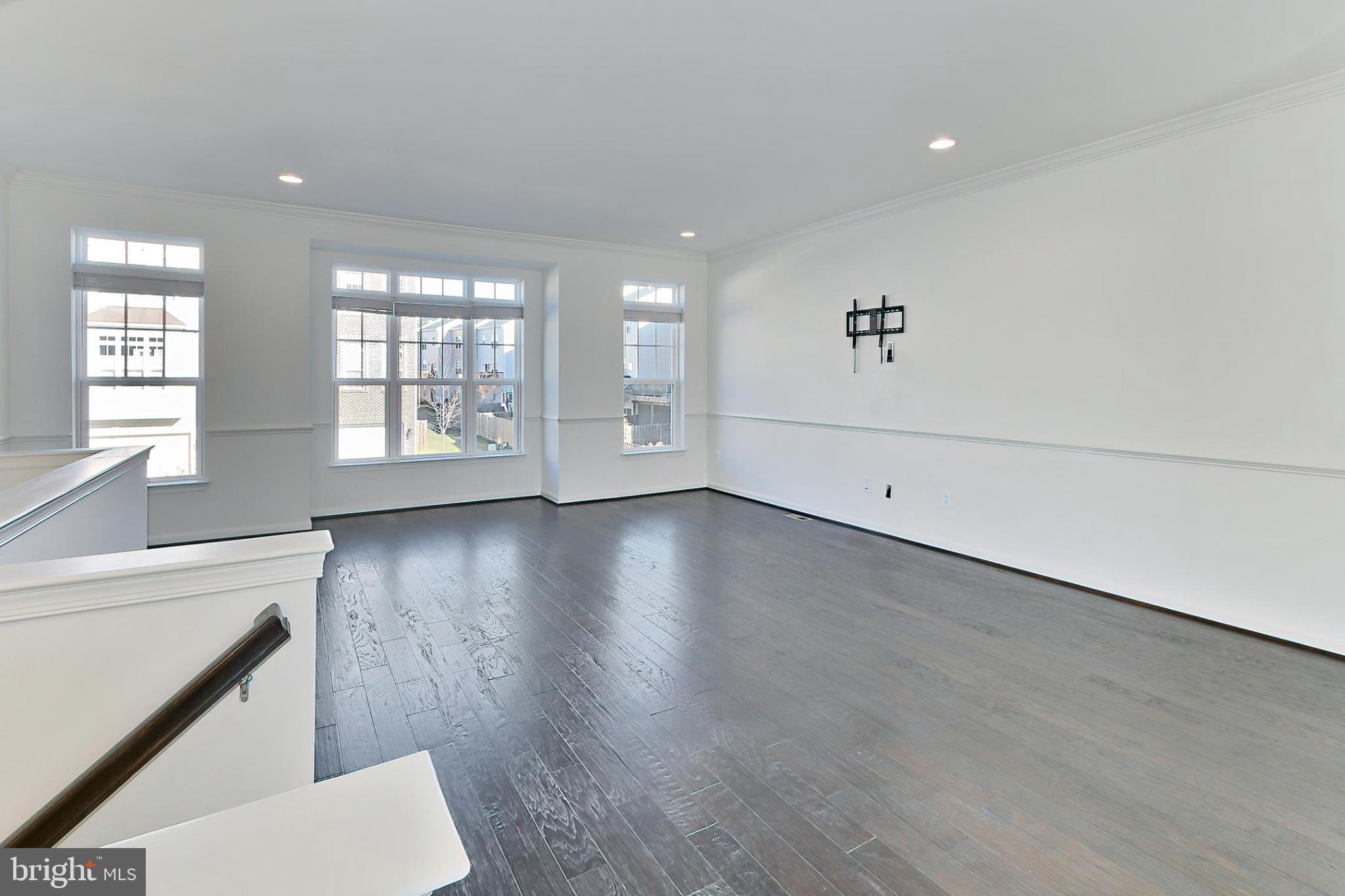 1111 11th Street Northwest, Unit 608 Washington, DC 20001 - Photo 25 of 29 an empty room with wooden floor and windows