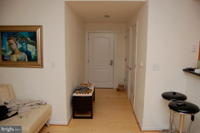1111 11th Street Northwest, Unit 608 Washington, DC 20001 - Photo 4 of 29 a bedroom with a bed and wooden floor
