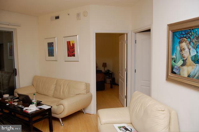 1111 11th Street Northwest, Unit 608 Washington, DC 20001 - Photo 8 of 29 a living room with furniture and a flat screen tv