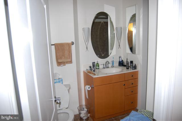1111 11th Street Northwest, Unit 608 Washington, DC 20001 - Photo 9 of 29 a bathroom with a sink mirror vanity and toilet