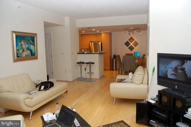 1111 11th Street Northwest, Unit 608 Washington, DC 20001 - Photo 10 of 29 a living room with furniture and a flat screen tv