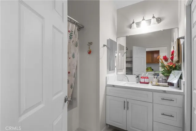 a bathroom with a sink vanity and a mirror