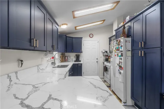a kitchen with refrigerator and window