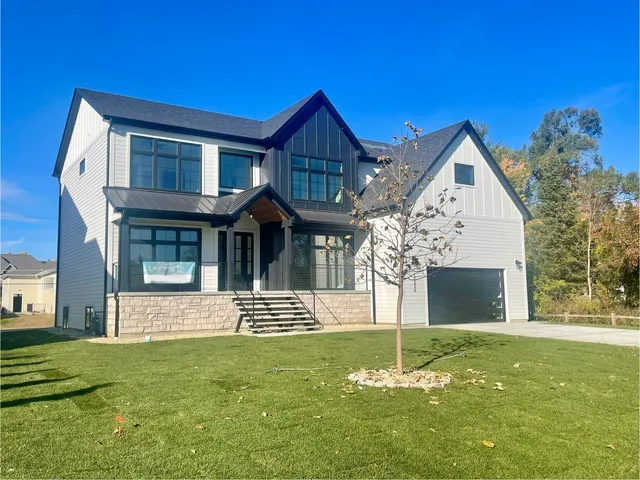 a front view of a house with a garden