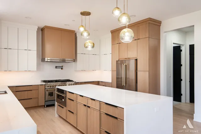 a kitchen with stainless steel appliances a stove a sink a refrigerator and a refrigerator