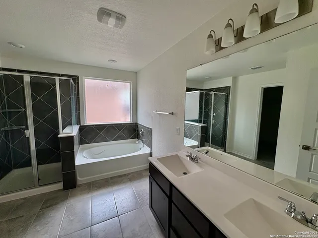 a bathroom with a tub sink and a mirror