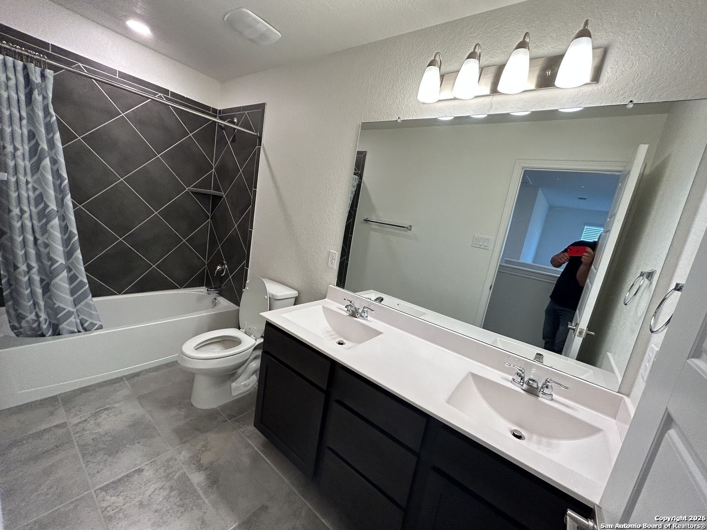 6608 Runaway Row Converse, TX 78109 - Photo 13 of 17 a bathroom with a sink vanity mirror and toilet