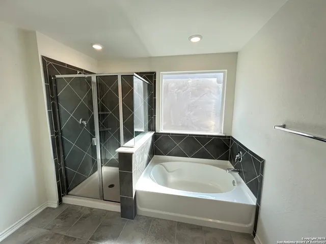 a bathroom with a bathtub and shower