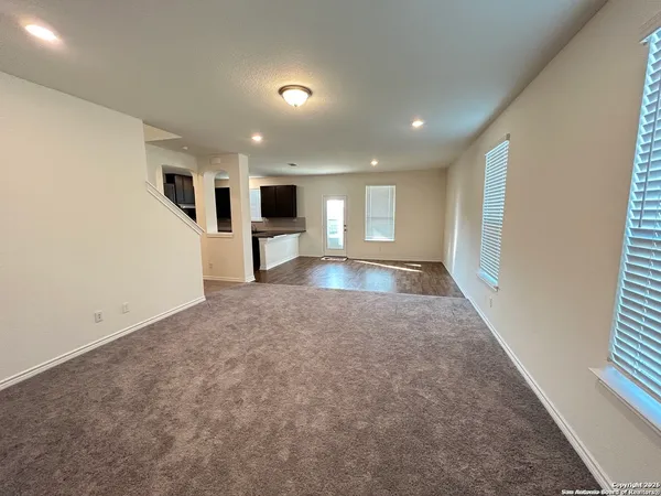 a view of a big room with windows and fireplace