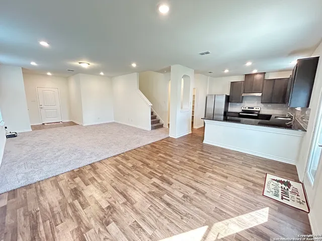 a view of kitchen with sink microwave and refrigerator