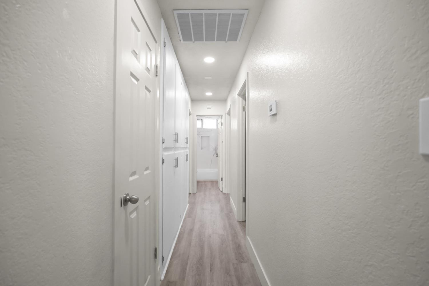 2832 Fowler Road Ceres, CA 95307 - Photo 16 of 28 a view of a hallway with wooden floor