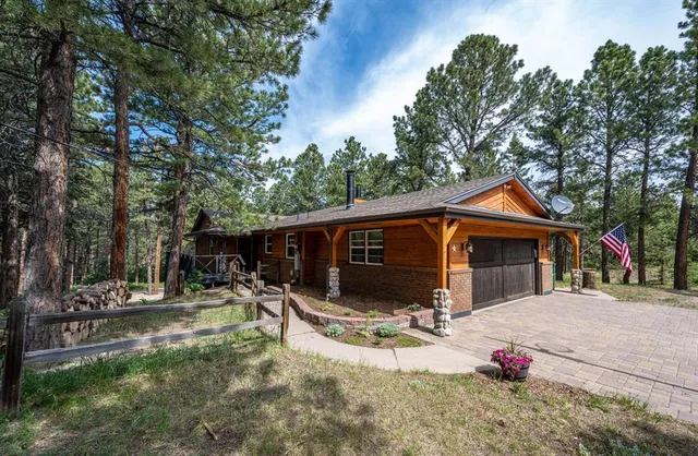 a view of patio with a table and chairs and a large tree