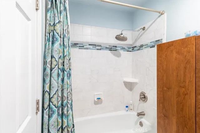 a bathroom with a bathtub and shower