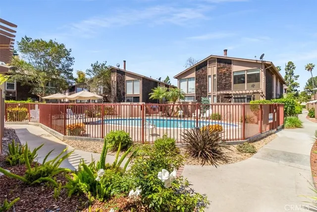a view of a house with wooden fence