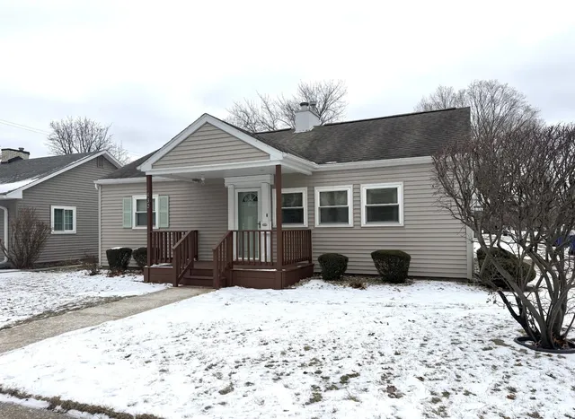 a view of a house with a yard covered in snow
