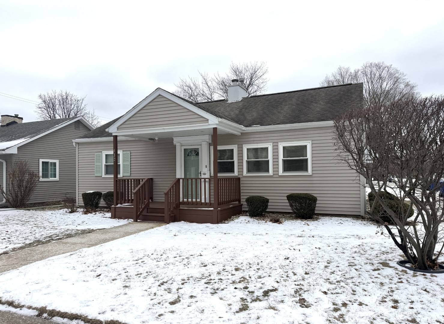 a view of a house with a yard covered in snow