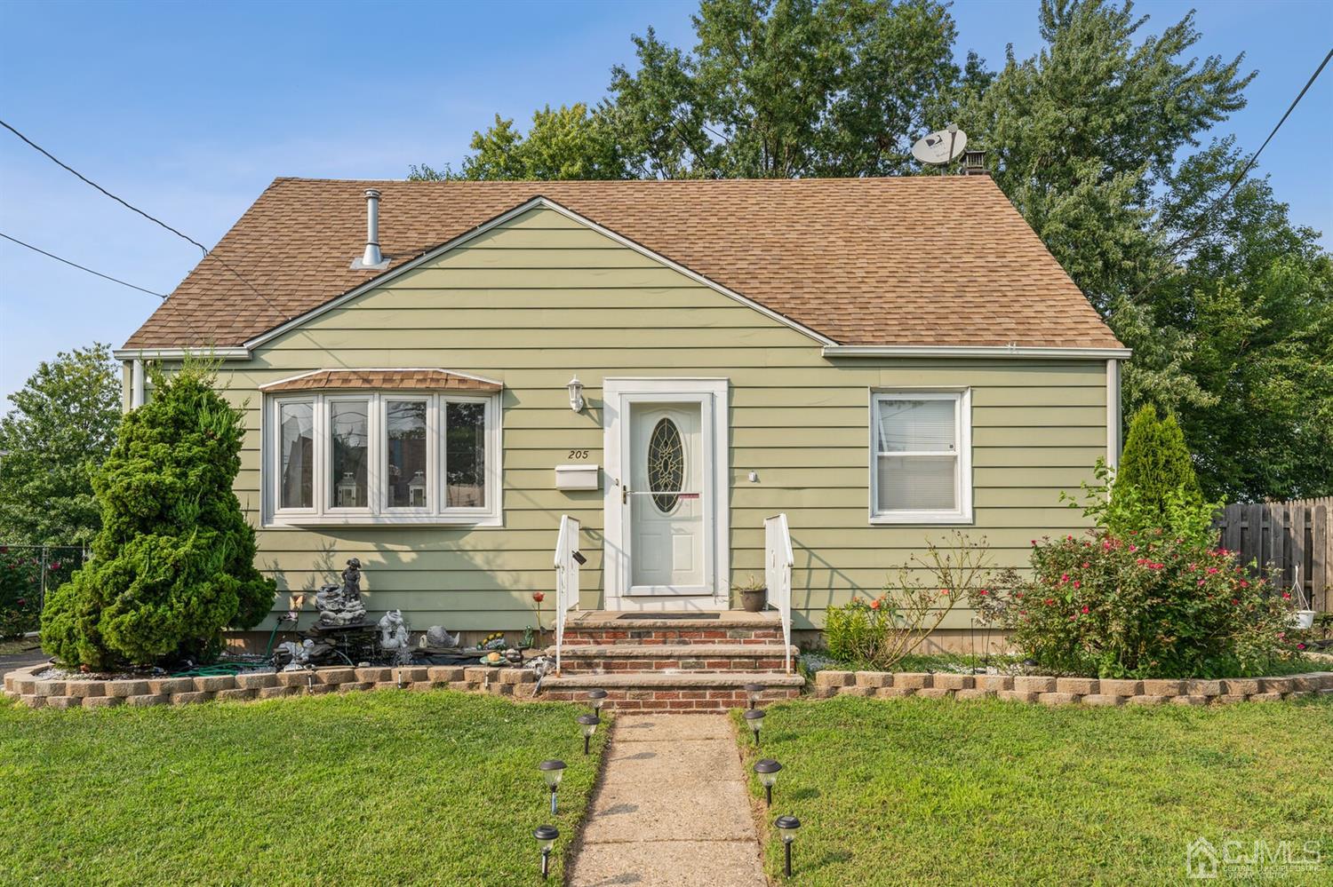 205 Midfield Road Colonia, NJ 07067 - Photo 2 of 26 a front view of a house with a yard