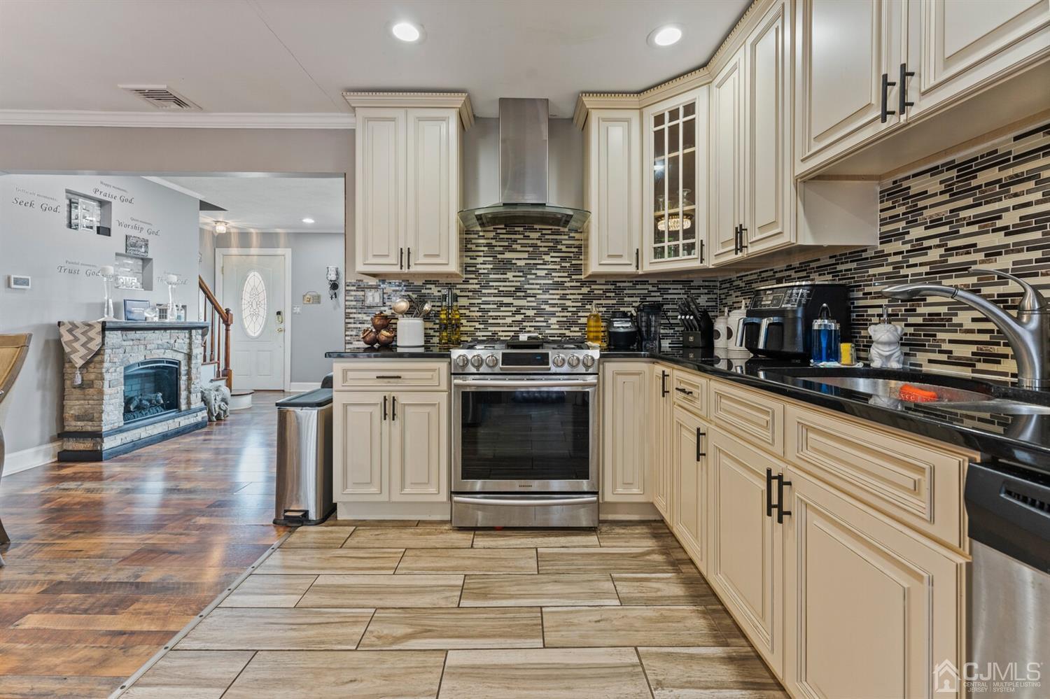 205 Midfield Road Colonia, NJ 07067 - Photo 11 of 26 a kitchen with stainless steel appliances granite countertop a stove and cabinets