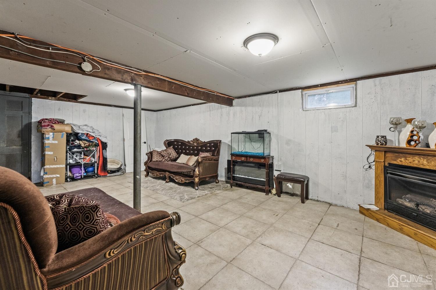 205 Midfield Road Colonia, NJ 07067 - Photo 20 of 26 a living room with furniture and a fireplace