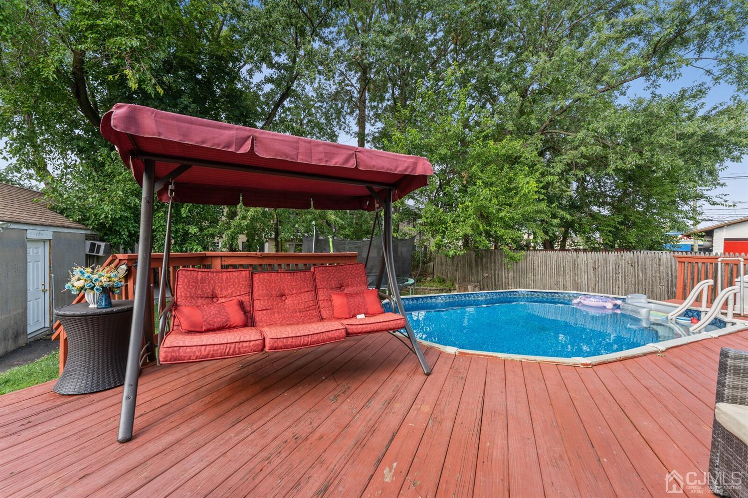 205 Midfield Road Colonia, NJ 07067 - Photo 22 of 26 a view of a wooden deck with furniture