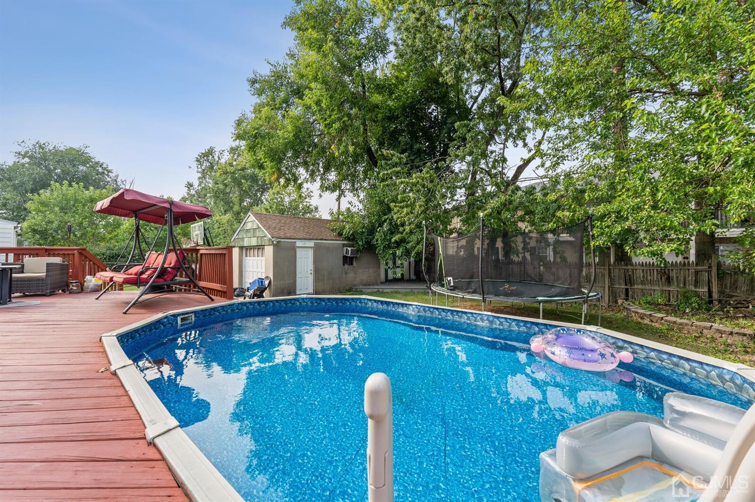 205 Midfield Road Colonia, NJ 07067 - Photo 24 of 26 a view of a swimming pool with lounge chairs in the patio