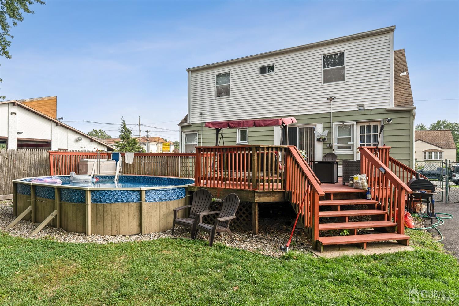 205 Midfield Road Colonia, NJ 07067 - Photo 26 of 26 a view of a house with a wooden deck and a chair