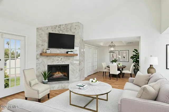 a living room with furniture a flat screen tv and a fireplace