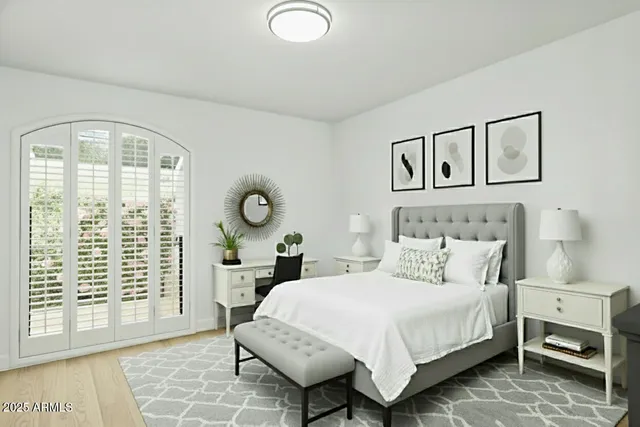 a bedroom with a large bed and a window