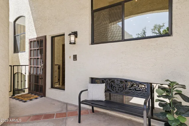 a view of a balcony with chairs and potted plant