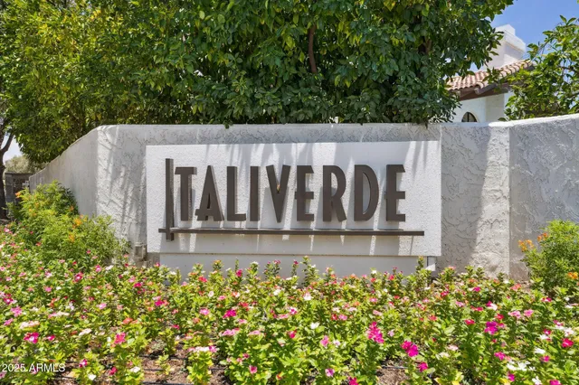 a view of a swimming pool with chairs in patio
