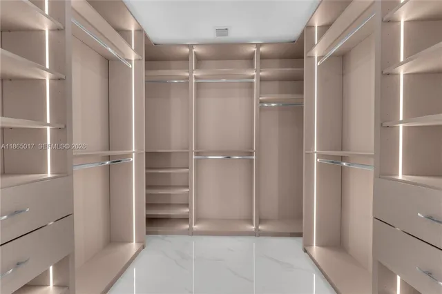 a view of walk in closet with empty racks