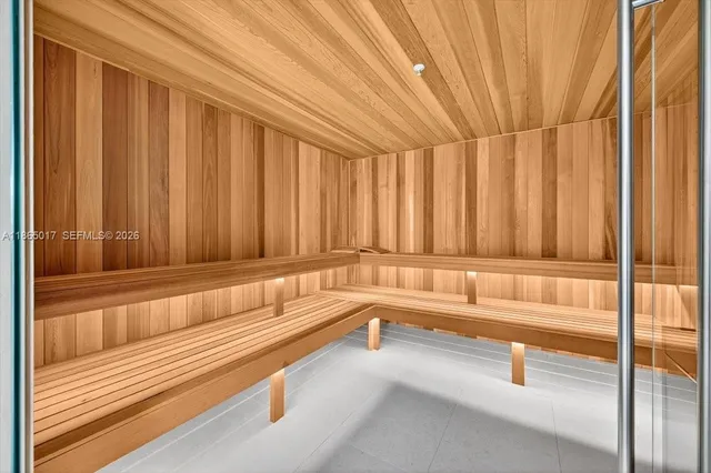 a dining room with wooden floor table and chairs