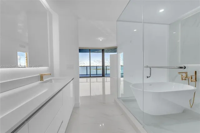 a large white kitchen with a large window