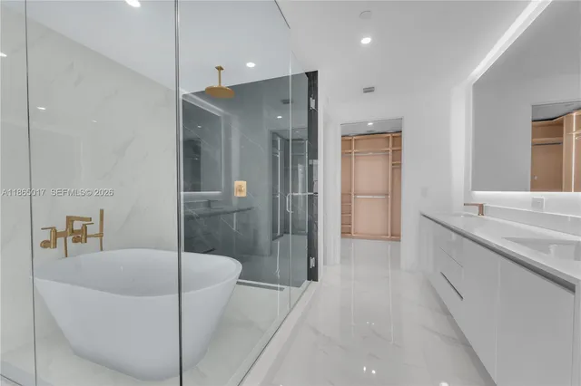 a bathroom with a bathtub and a shower
