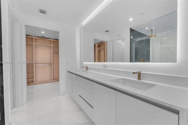 a bathroom with a double vanity sink and a mirror
