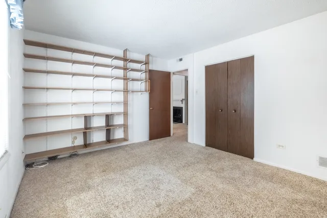 a view of an empty room with shelves