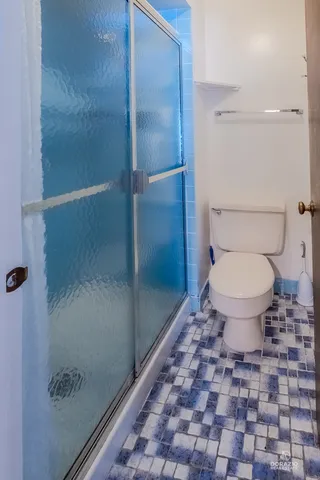 a bathroom with a toilet and a shower