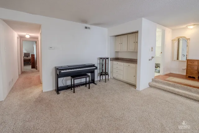 a bedroom with a bed and a chair in it