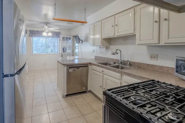 a kitchen with granite countertop a sink stove and cabinets