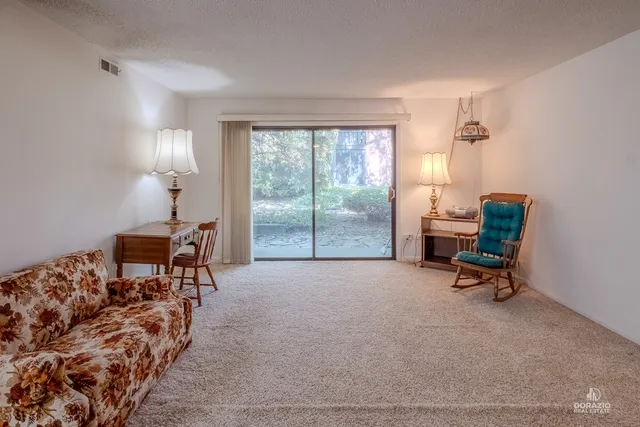 a bed room with a bed and a chair