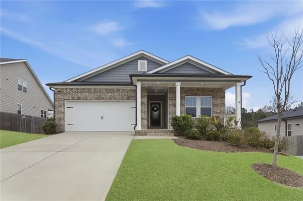 a front view of a house with yard