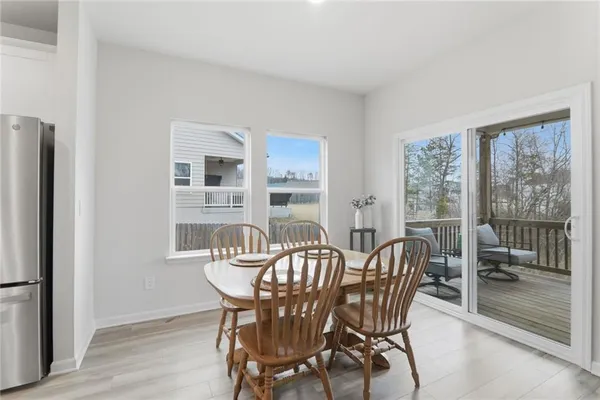 a view of a dining room with furniture large windows and wooden floor