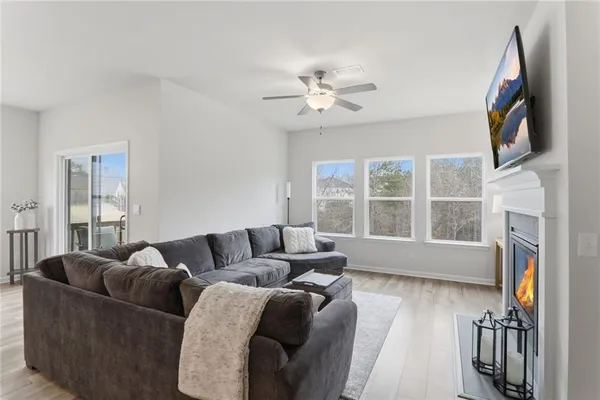 a living room with furniture a flat screen tv and a fireplace