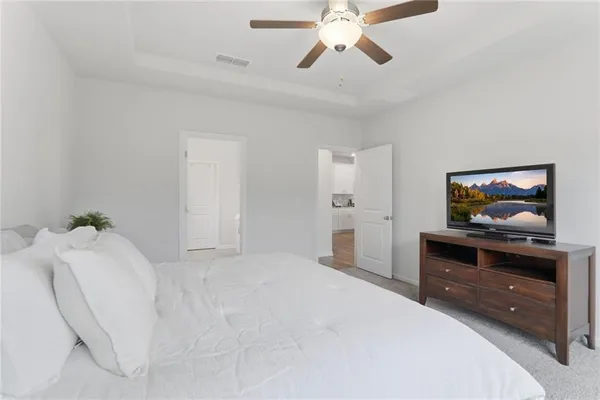a bedroom with a bed and a chandelier