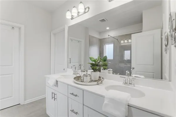 a bathroom with a sink double vanity and a mirror