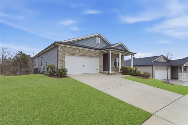 a front view of a house with a yard and garage
