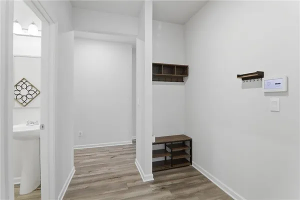 a view of a hallway with wooden floor