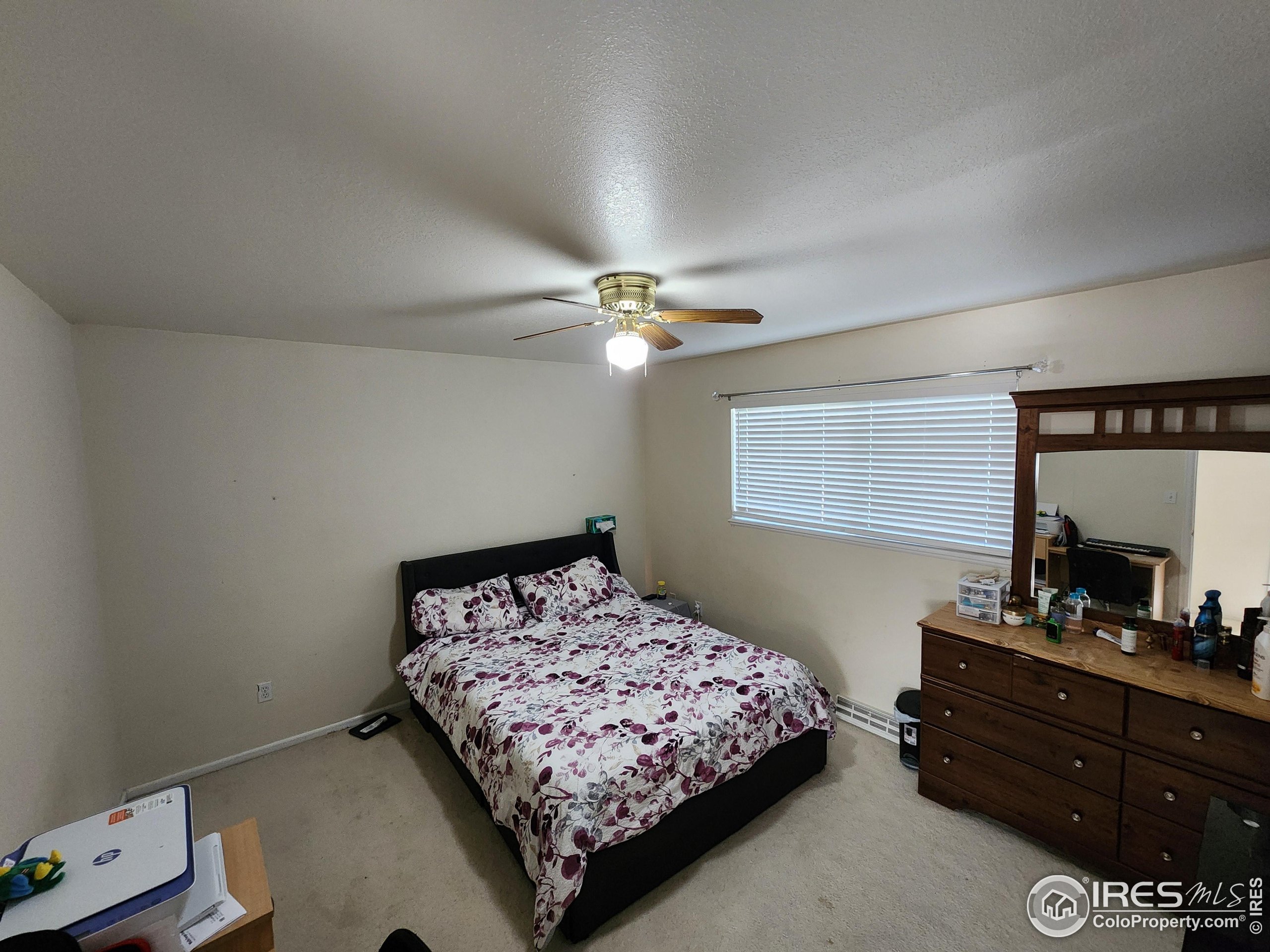 1324 Dawes Street Sterling, CO 80751 - Photo 13 of 39 a bedroom with a bed and a dresser in it